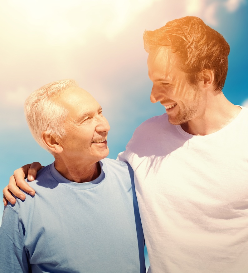 Composite image of adult son hugging his old father adult son hugging his old father